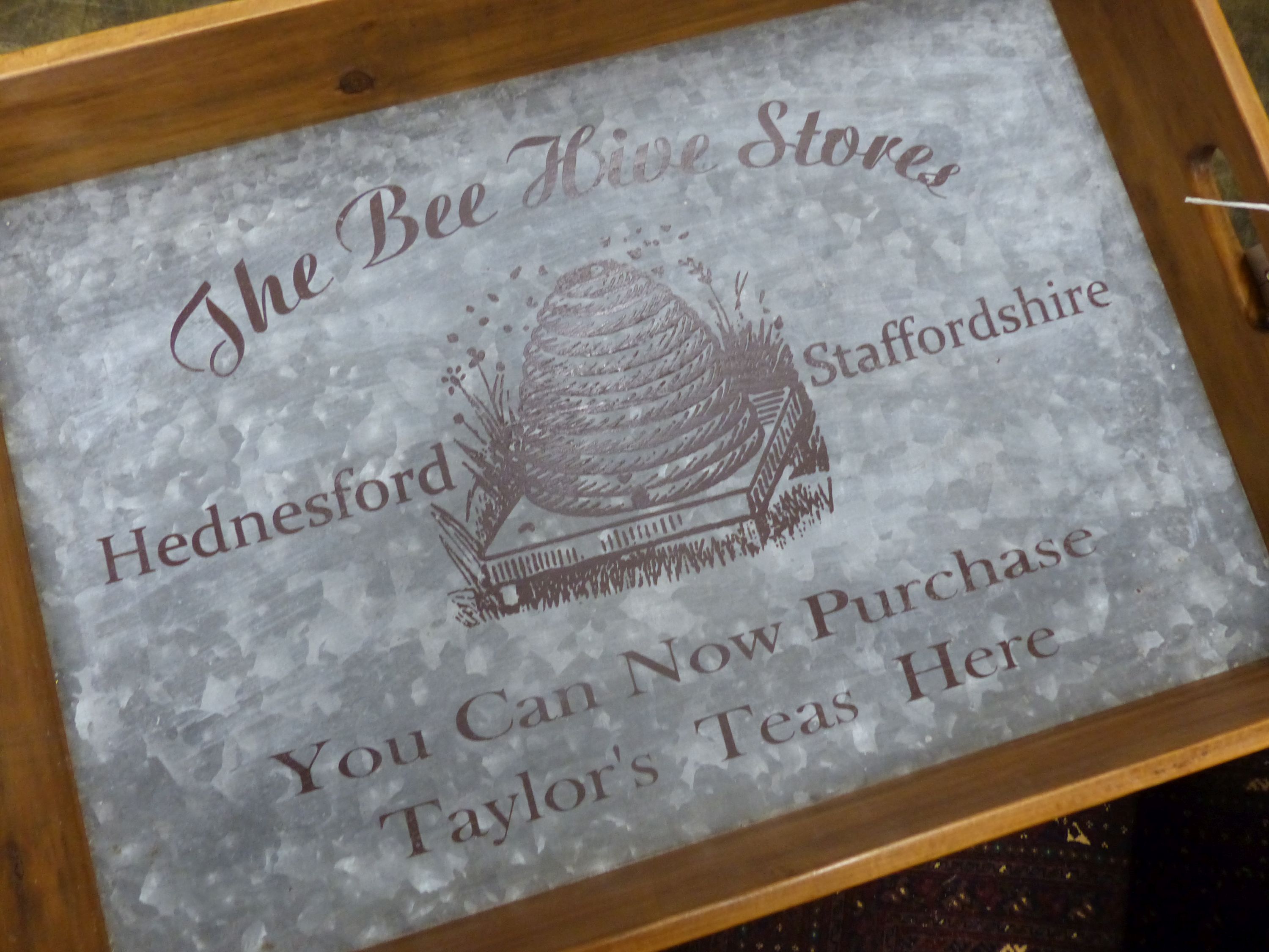 'The Bee Hive Stores', a rectangular wooden produce display tray on folding stand, width 65cm, depth 44cm, height 78cm